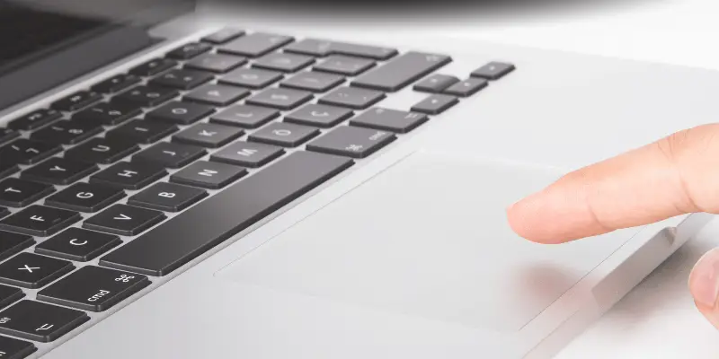 Close-up of a finger on a laptop touchpad
