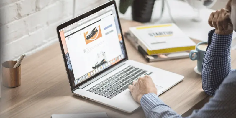 Man working on a business project with a laptop in a clean workplace.