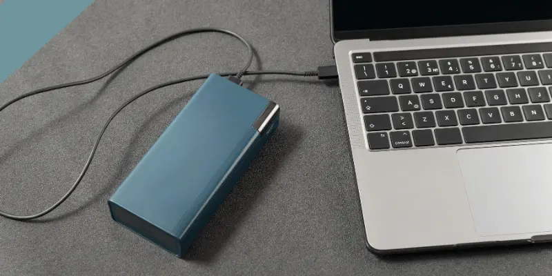 Portable power solution with a power bank charging a laptop