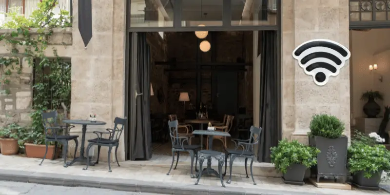 Street-side café with Wi-Fi symbol, ideal for working or unwinding with a coffee