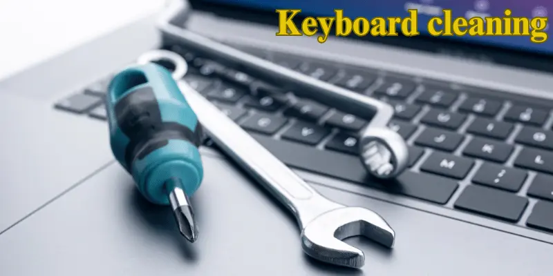 Close-up of tools on a keyboard, illustrating steps for laptop keyboard cleaning