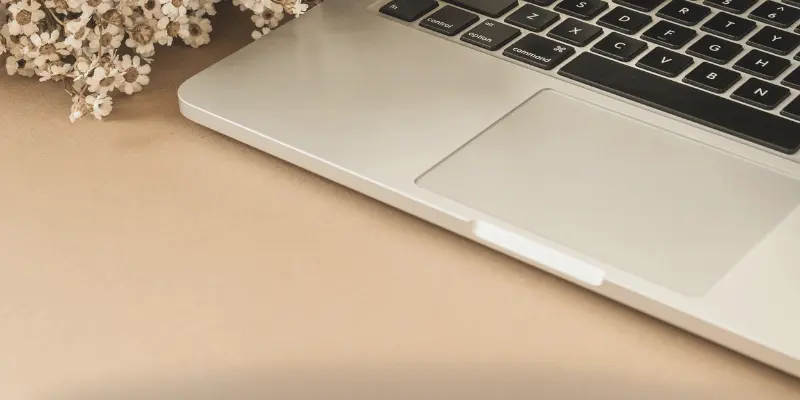 Sleek laptop design with beige floral aesthetic