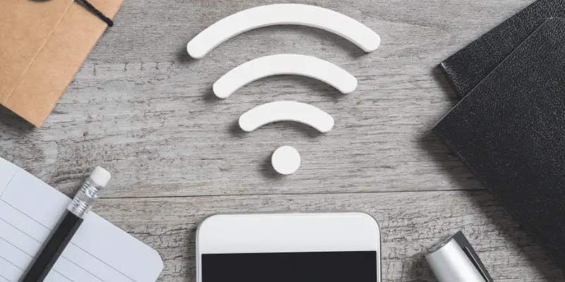 WiFi logo on a workspace desk with phone and notepad